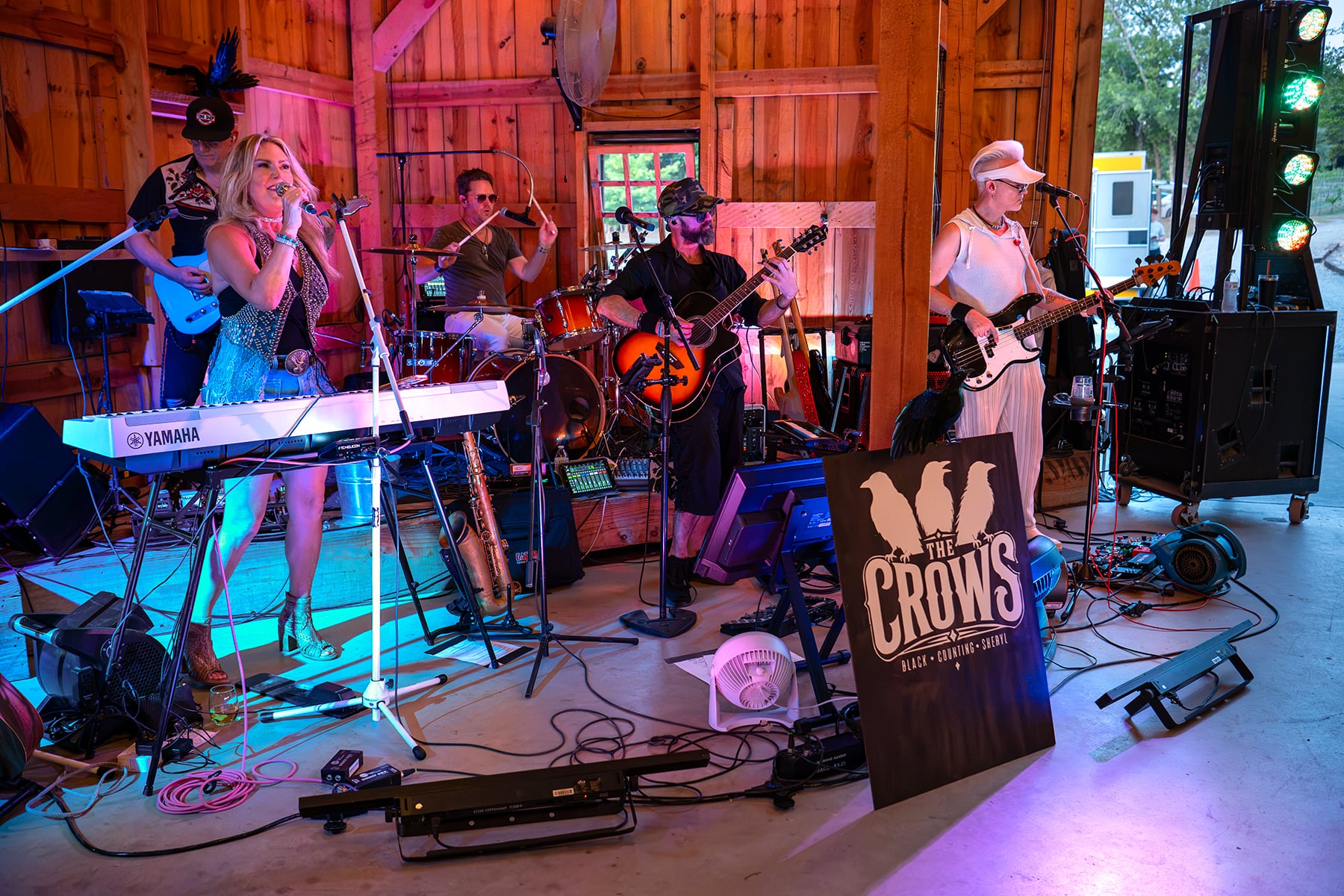 The Crows performing live as a five-piece band in a warmly lit barn venue.